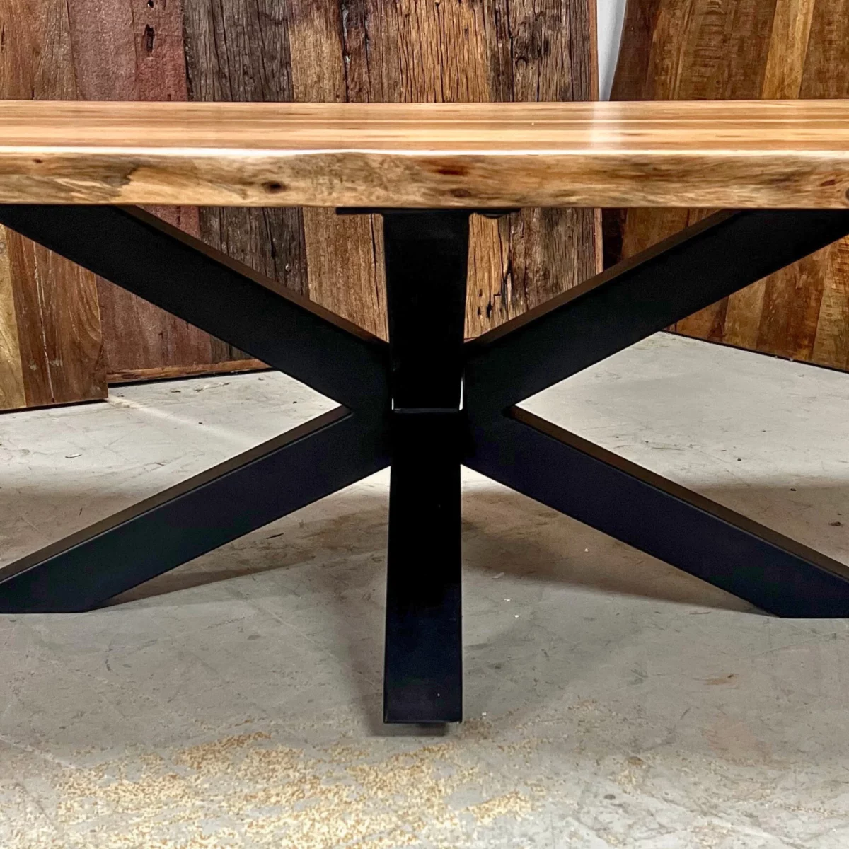 A coffee table with a central star-shaped leg