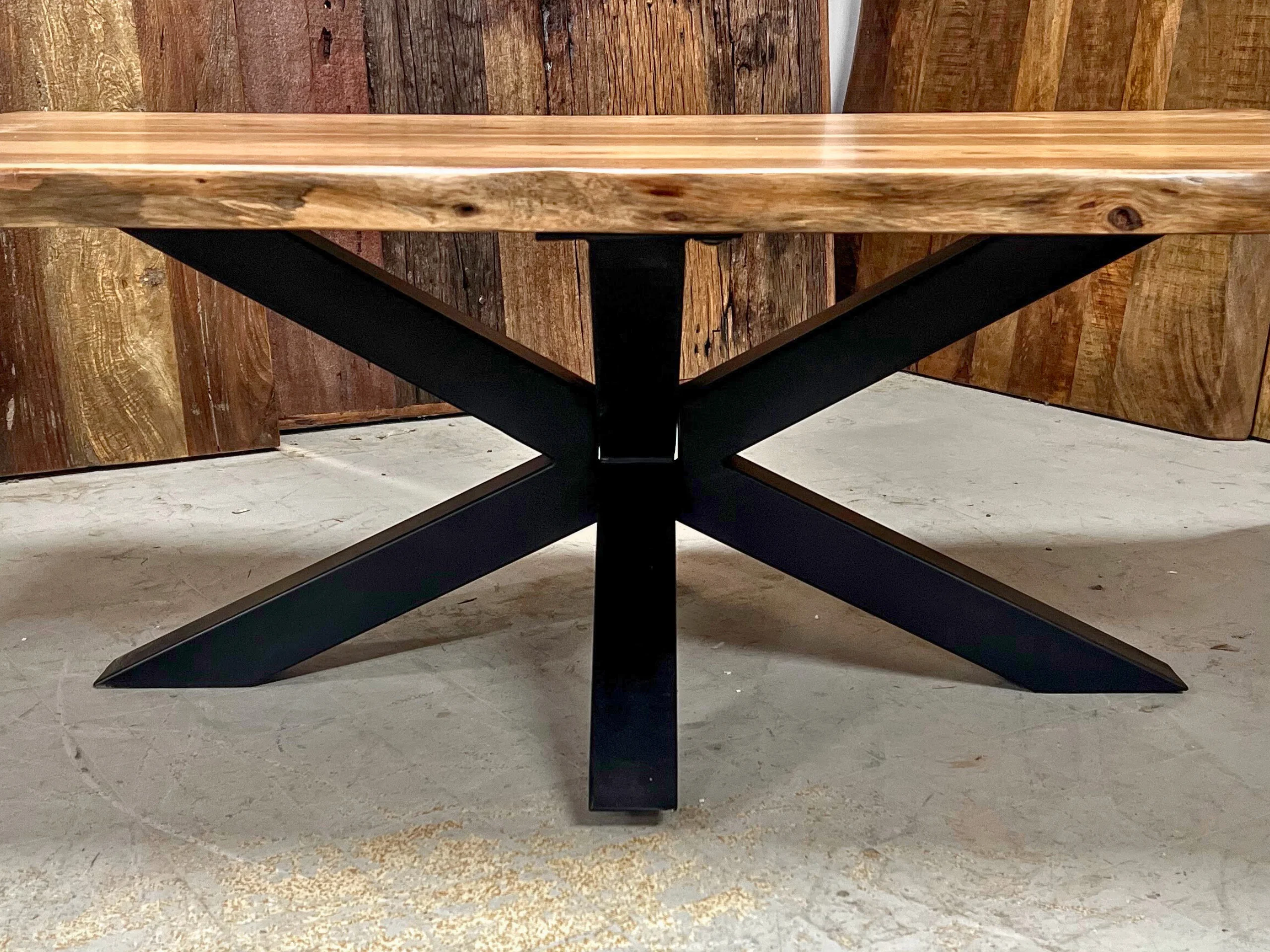 A coffee table with a central star-shaped leg