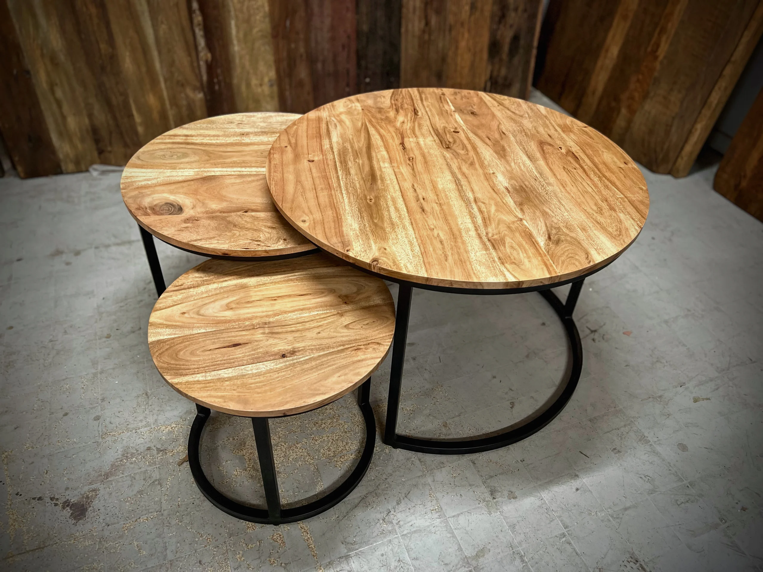 Three acacia round side tables