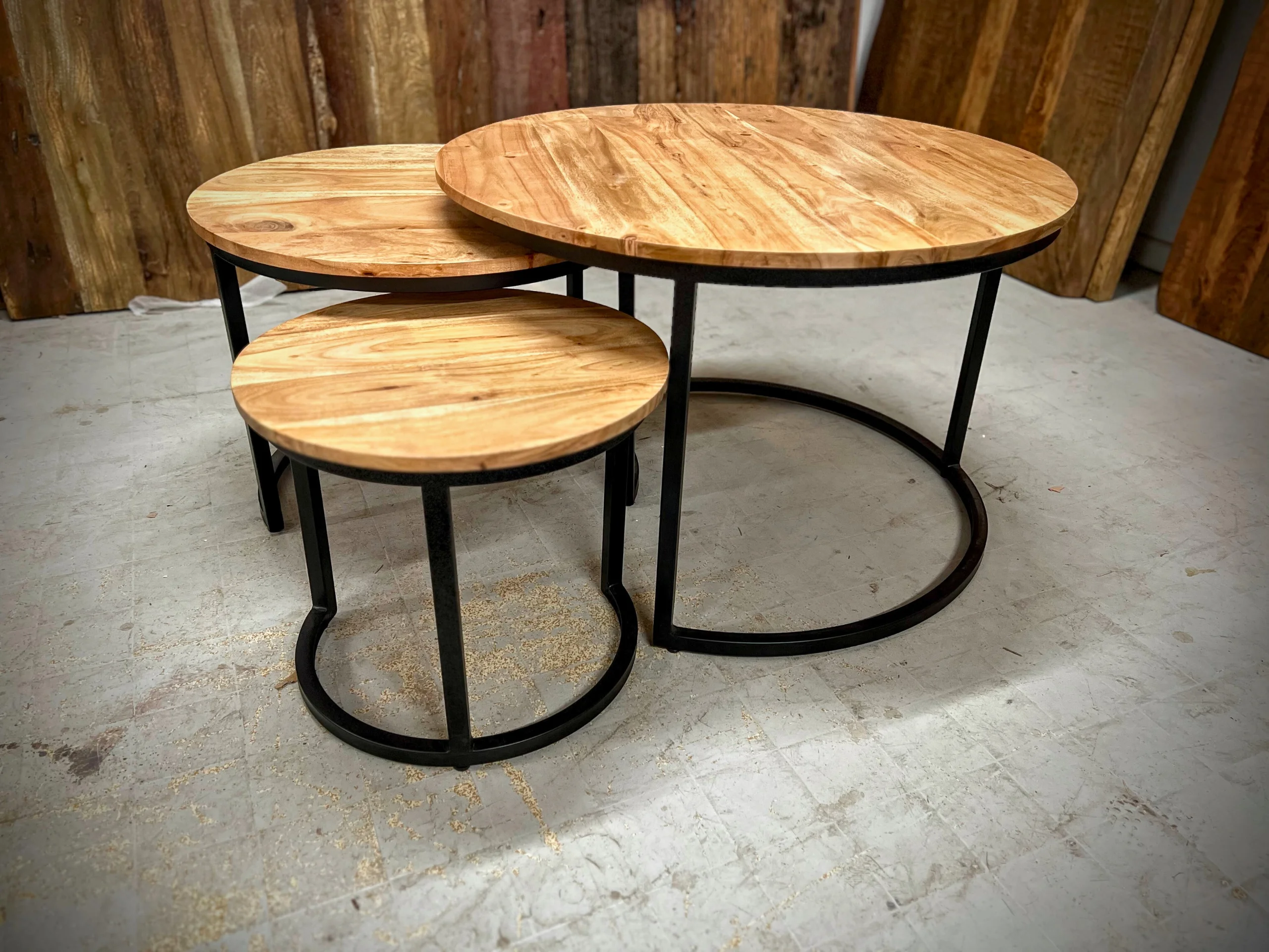 Three acacia round side tables