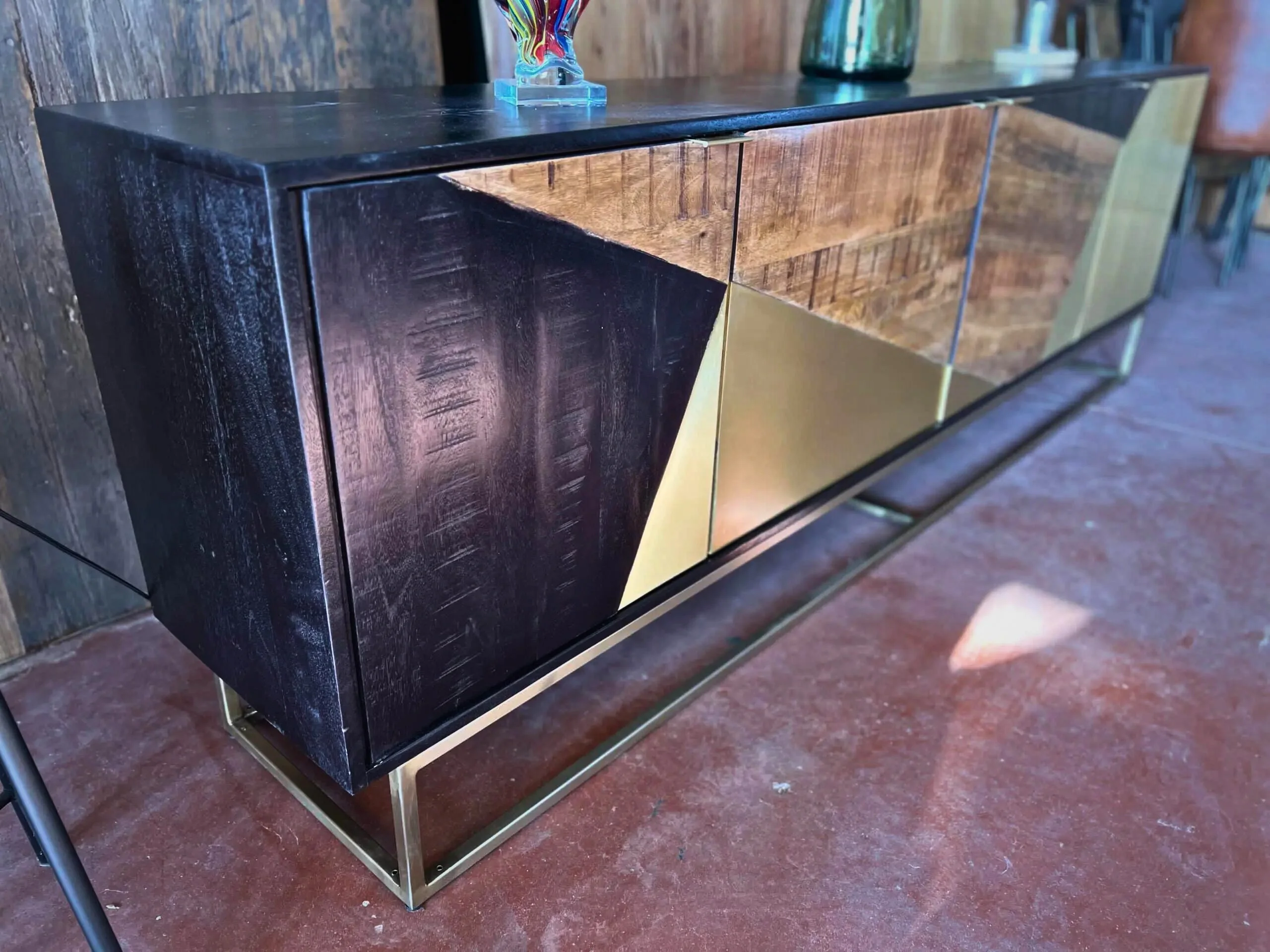 A sideboard in solid wood and gold metal
