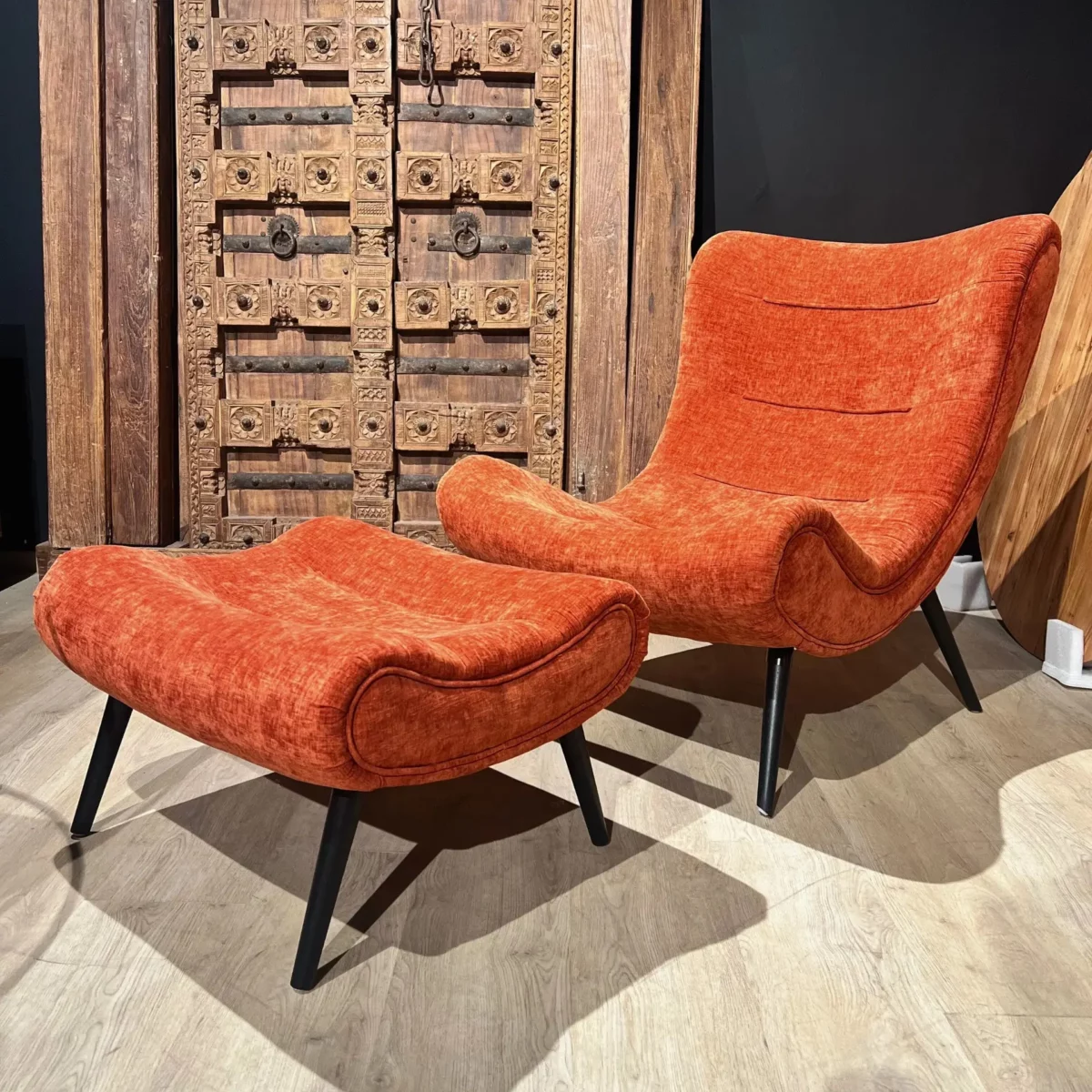 A terracotta-colored velvet armchair