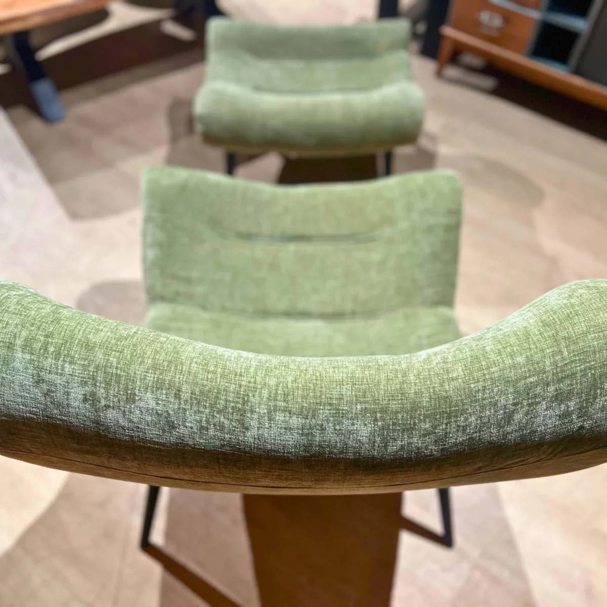 Le dossier d'un fauteuil en velours olive