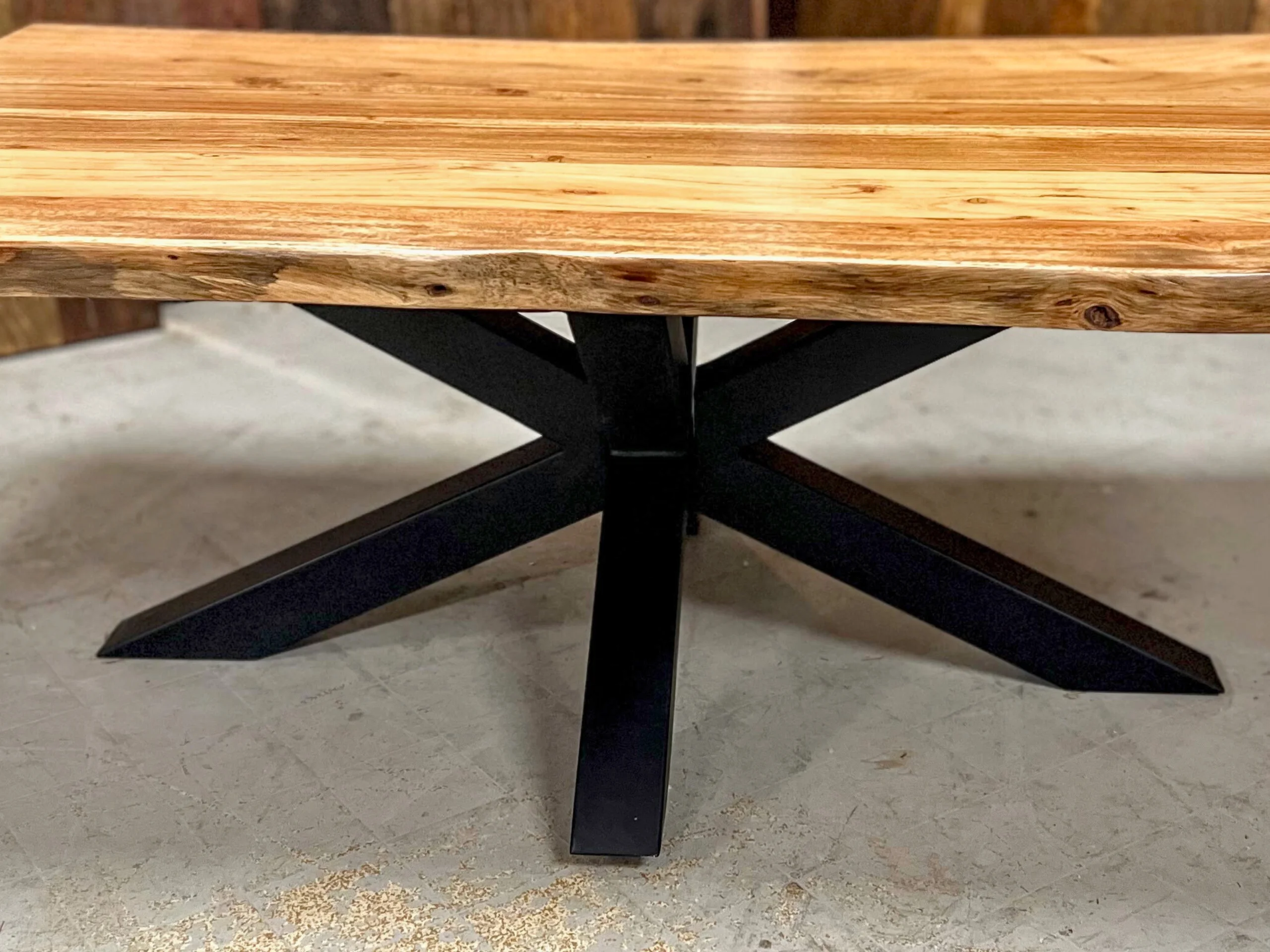 A coffee table with a central star base