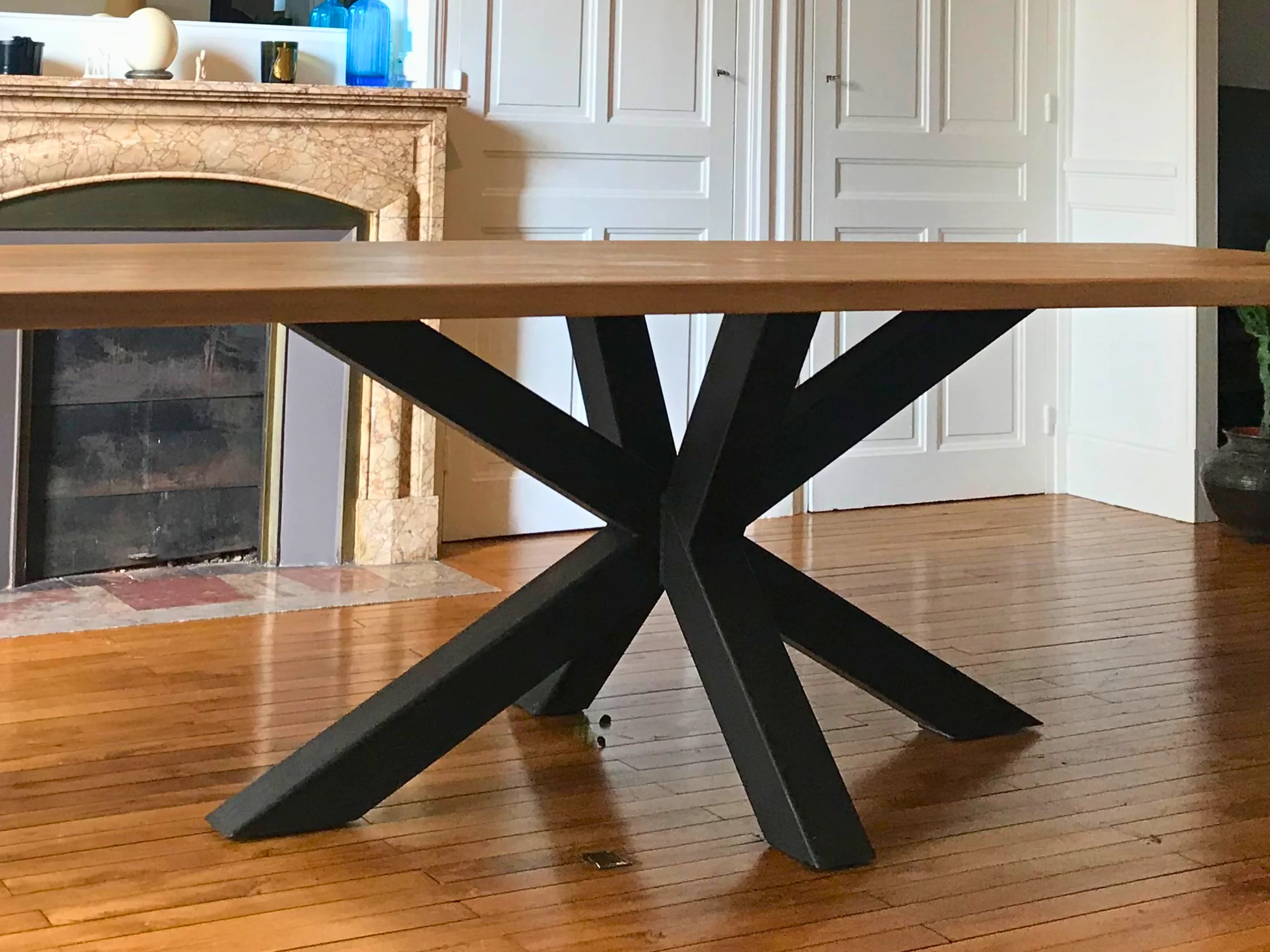 A living room with a table with a black metal base