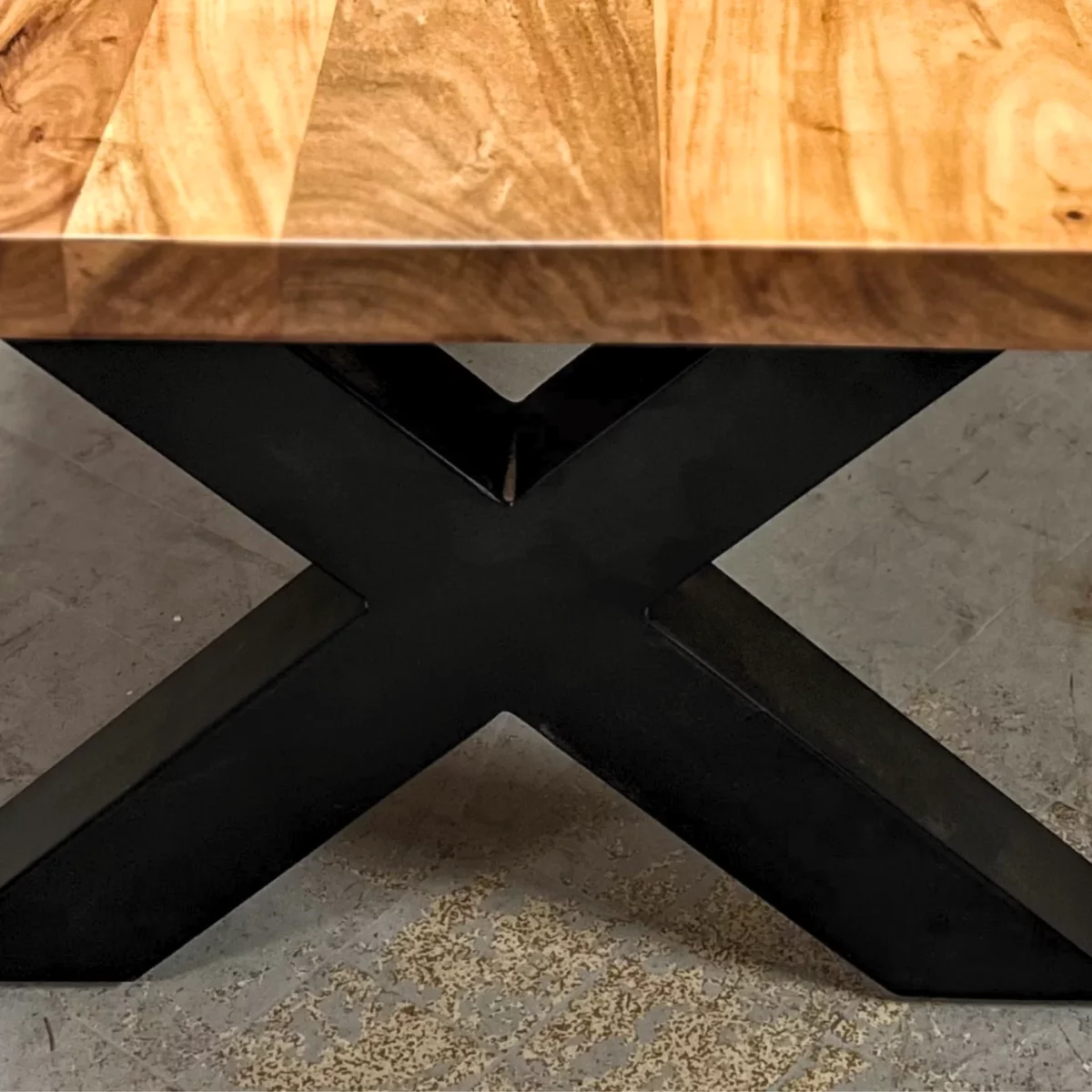A coffee table leg made of steel, in a cross shape
