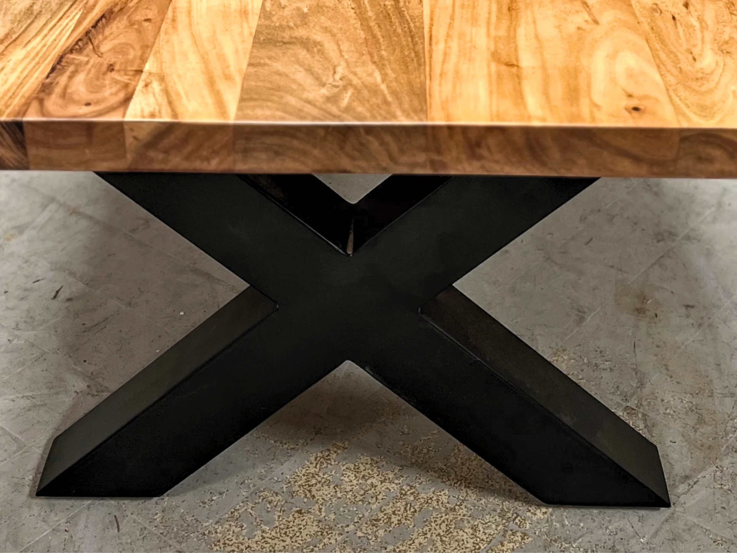 A coffee table leg made of steel, in a cross shape
