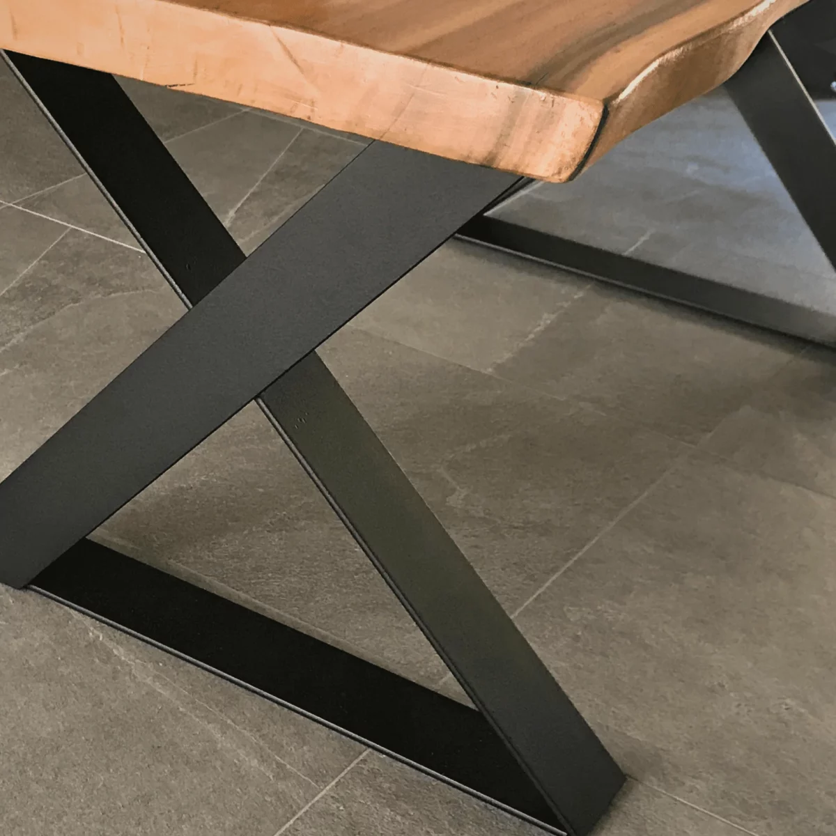 Crossed steel table legs in a kitchen