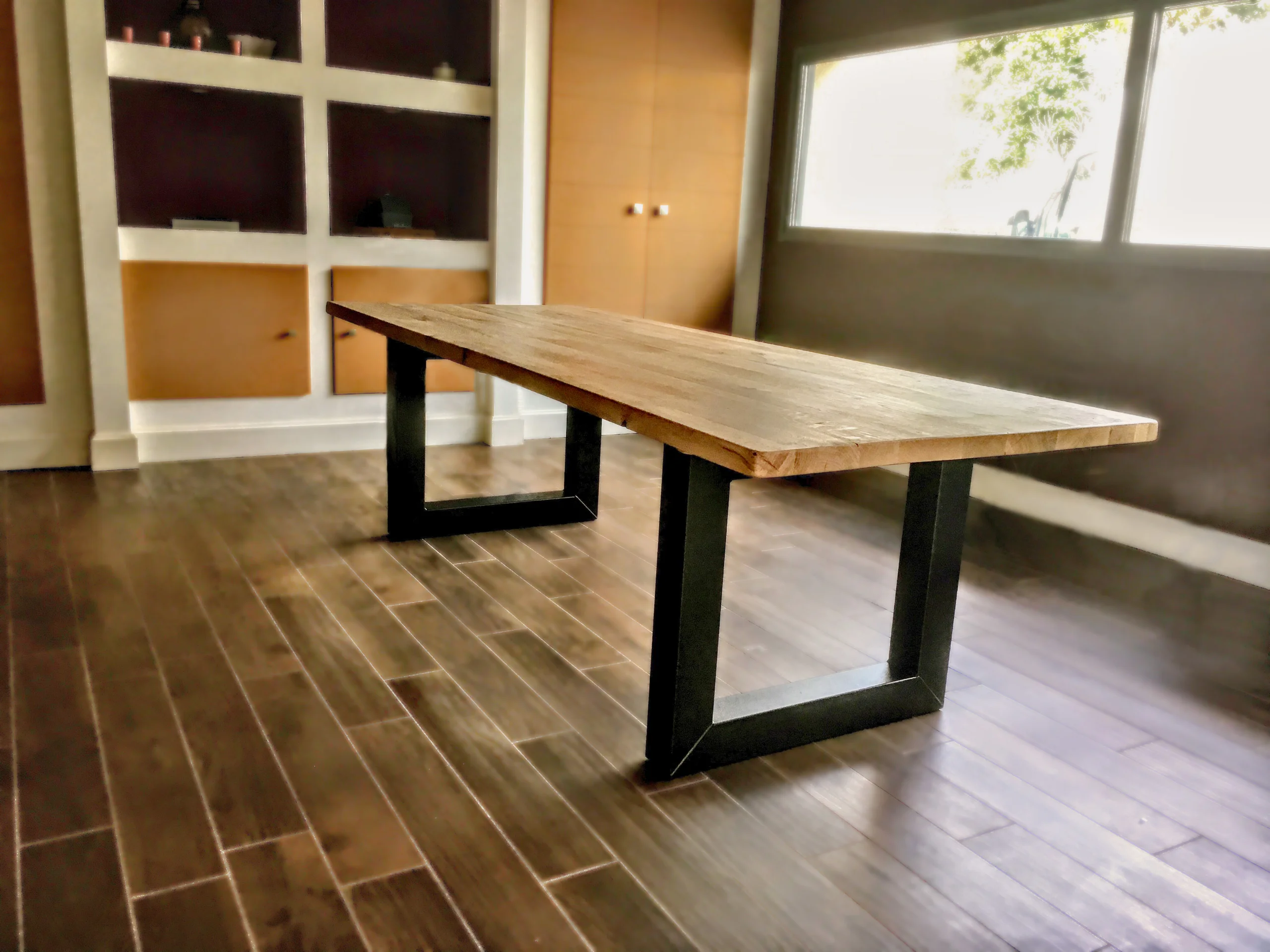 A living room with a dining table with U-shaped legs