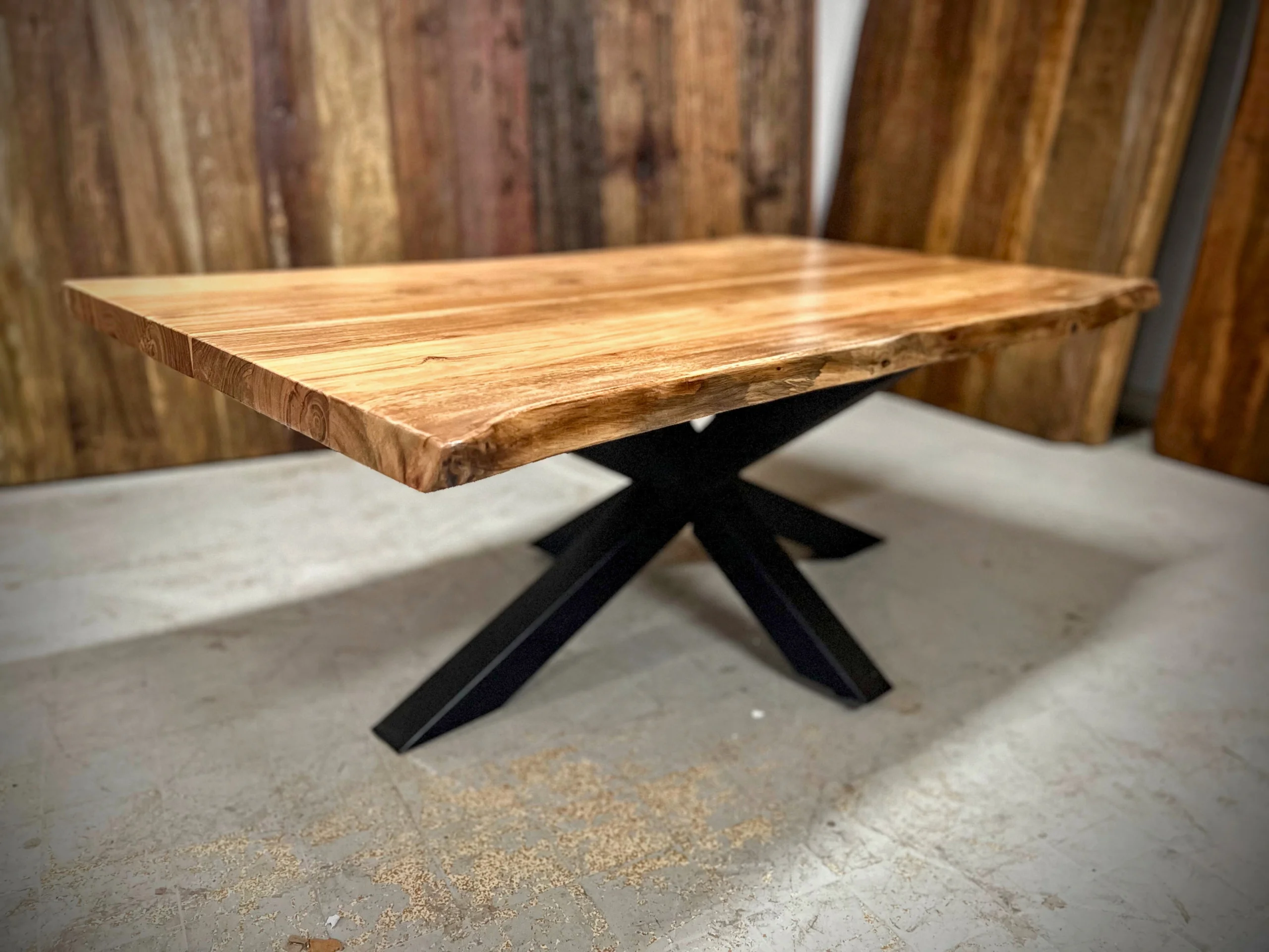A coffee table with a central leg in a woodworking shop